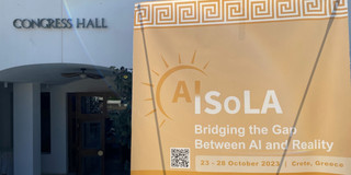 Foto eines Banners der AISoLA vor der Congress Hall in Griechenland