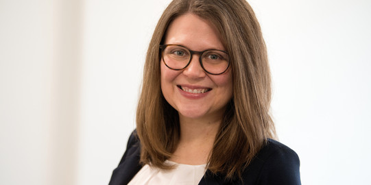 Porträtfoto von Justine Stang-Rabrig vor einem hellen Hintergrund
