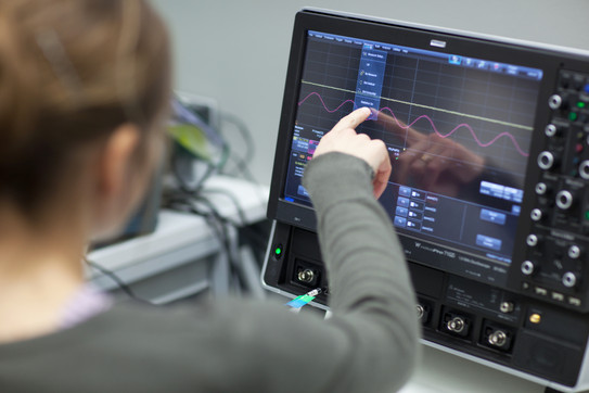 Bildschirmansicht Person zeigt auf Monitor mit physikalischer Skala