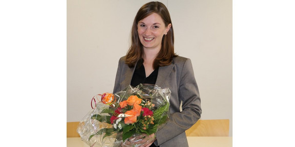 Dr. Ramona Lorenz holds a bouquet of flowers in her hand