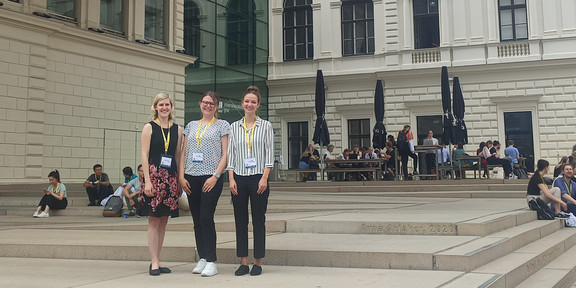 Anne Kosubek, Justine Stang-Rabrig und Leonie Dargiewicz stehen zusammen vor dem Veranstaltungsgebäude 