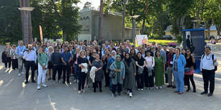 Gruppenfoto der teilnehmenden Wissenschaftlerinnen und Wissenschaftler vor Bäumen an einem sonnigen Tag