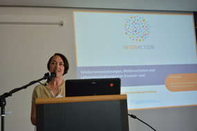 Foto von Prof. Dr. Tina Seidel am Rednerpult mit Startfolie ihrer Präsentation im Hintergrund