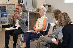 Foto der Podiumsdiskussion mit verschiedenen Referent*innen